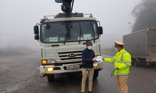 Lực lượng CSGT phát tờ rơi cảnh báo sương mù cho các lái xe. Ảnh: Khánh Linh.