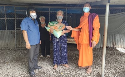 Đại đức Lâm Chanh Sầm Nang, Phó Trụ trì chùa Cần Đước tặng quà cho người già neo đơn. Ảnh: Phạm Đông