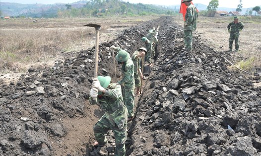 Bộ đội giúp dân đào kênh dẫn nước, giải hạn cho đất sản xuất tại Đắk Lắk. Ảnh: Thanh Hải