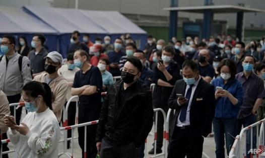 Lo ngại về việc đóng cửa do COVID-19 đã gây ra tình trạng tích trữ nhu yếu phẩm và xếp hàng dài để thử nghiệm hàng loạt ở Bắc Kinh vào ngày 25.4. Ảnh: AFP