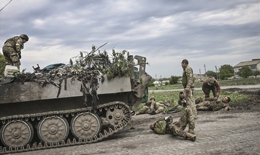 Quân nhân Ukraina hỗ trợ đồng đội gần chiến tuyến ở Donbass, ngày 21.5.2022. Ảnh: AFP