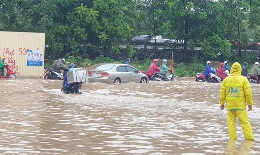 Nước ngập sâu quá nửa bánh xe tại đường gom đại lộ Thăng Long, Hà Nội. Ảnh: Trần Tuấn.