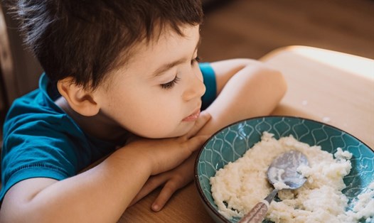 Cha mẹ hãy tìm hiểu nguyên nhân khiến trẻ nhỏ liên tiếp bỏ mứa, đổ thức ăn thừa. Ảnh: Xinhua