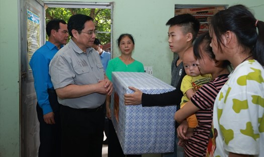 Thủ tướng Phạm Minh Chính trao quà tới vợ chồng anh Sùng Mí Ná và chị Lù Thị Tịnh. Ảnh: Hải Nguyễn
