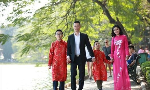 Một gia đình du xuân bên Hồ Gươm. Ảnh: Hải Nguyễn