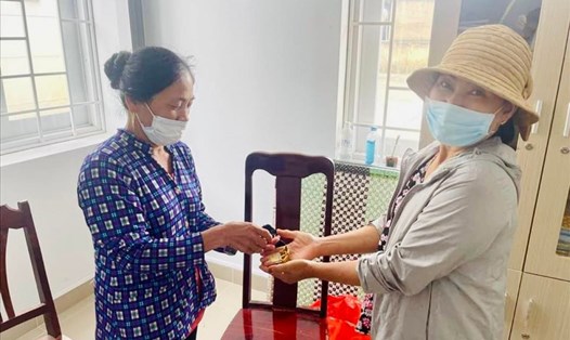 Bà Võ Thị Tuyết Hương (bìa trái) trao trả số vàng cho người đánh mất. Ảnh: Hà Anh Chiến