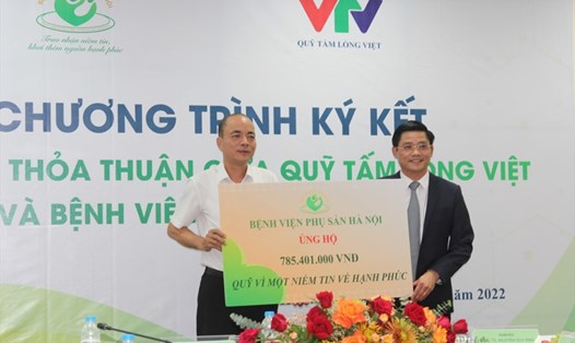 Giám đốc Bệnh viện Phụ sản Hà Nội Nguyễn Duy Ánh trao số tiền ủng hộ cho Quỹ Tấm Lòng Việt nhằm giúp đỡ các cặp vợ chồng mang gen bệnh có hoàn cảnh khó khăn. Ảnh: Minh Khuê