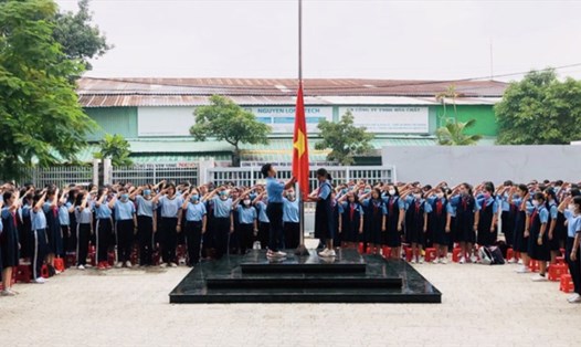 Học sinh Trường THCS Nguyễn Văn Tố (quận 10, TPHCM) thực hiện nghi thức chào cờ. Ảnh: NT