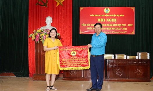 Chủ tịch Liên đoàn Lao động tỉnh Nam Định Vũ Văn Nghĩa  trao Cờ thi đua của Tổng Liên đoàn Lao động Việt Nam cho đơn vị xuất sắc. Ảnh: CĐNĐ
