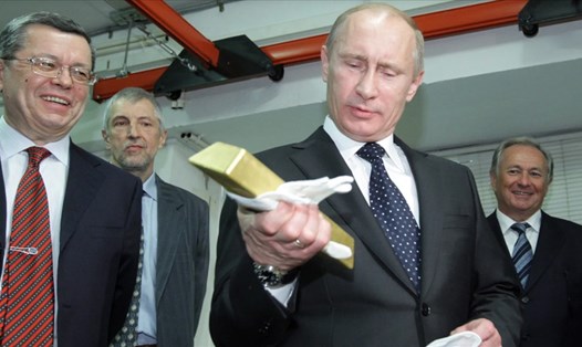 Tổng thống Vladimir Putin kiểm tra vàng thỏi của Nga. Ảnh: AFP
