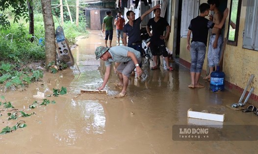 Công nhân Hòa Bình oằn mình dọn dẹp hậu quả sau mưa lũ. Ảnh: Anh Vũ