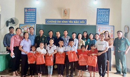 Các mạnh thường quân trao tặng SGK và vở viết cho các em học sinh tại điểm trường Phú Lâm - Hương Khê. Ảnh: La Giang