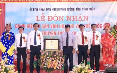 Trao Bằng chứng nhận di sản văn hóa phi vật thể quốc gia Lễ hội truyền thống xã Đại Đồng cho lãnh đạo huyện Vĩnh Tường. Ảnh: TTXVN