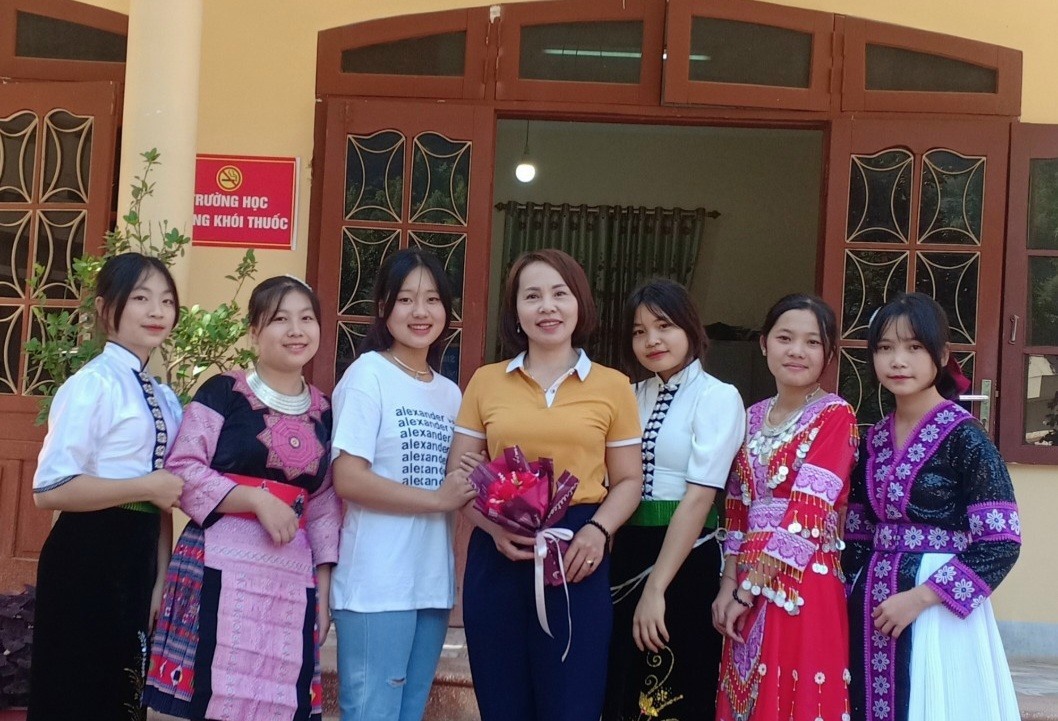 Cô giáo Phạm Thị Hồng Phượng ( áo vàng, đứng giữa) cùng học sinh. Ảnh: NVCC