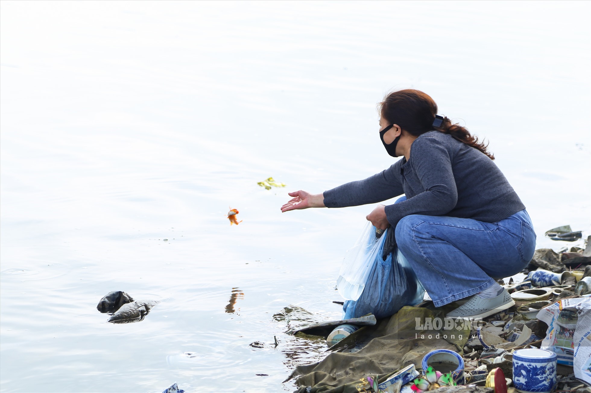 Có người lựa chọn xuống tận khu vực bờ sông để trực tiếp thả. Ảnh: Linh Trang - Việt Anh