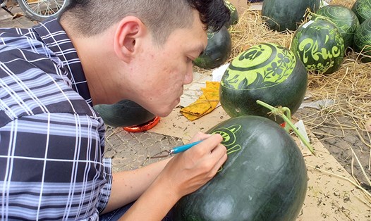 Nguyễn Phước Duy, thành phố Bạc Liêu, tỉnh Bạc Liêu vẽ trực tiếp lên quả dưa hấu phục vụ Tết Quý Mão . Ảnh: Nhật Hồ