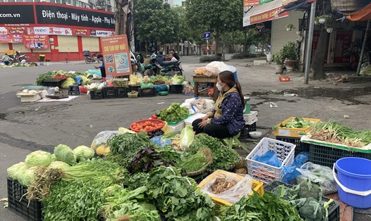 Tiểu thương bày bán các loại rau ngay trước cổng chợ Hợp Nhất (phường Yên Hoà, quận Cầu Giấy). Ảnh: T.Vương