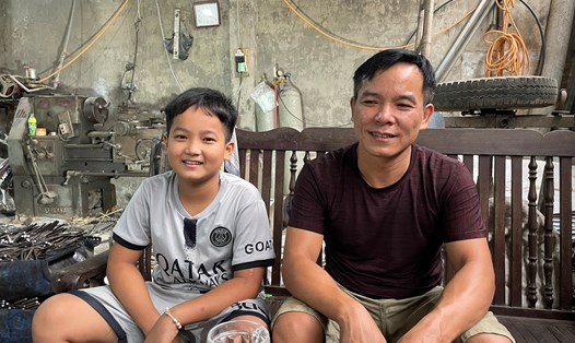 Anh Đỗ Văn Chính (xã Phùng Xá, Thạch Thất, Hà Nội) cùng cậu con trai đã may mắn qua cơn nguy kịch của bệnh sốt xuất huyết. Ảnh: Khánh Linh