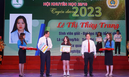 Ông Lê Thanh Hưng, Tổng Giám đốc Tập đoàn Công nghiệp Cao su Việt Nam (bên phải) trao học bổng cho sinh viên vượt khó. Ảnh: Phương Ngân