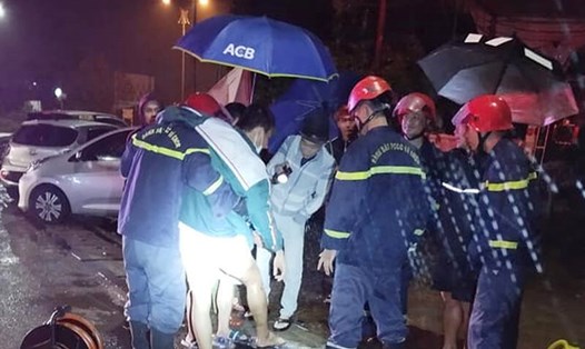 Cảnh sát cứu nạn, cứu hộ đến giải cứu nạn nhân bị mắc kẹt chân dưới nắp cống. Ảnh: Công an HT.