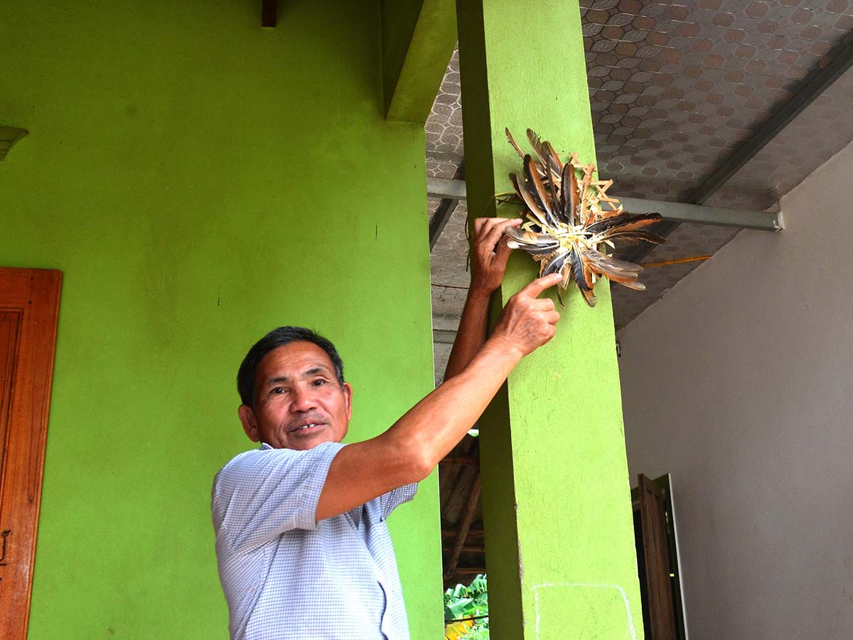 Việc treo tấm phên nứa có cài lông gà lên cột nhà có ý thông báo rằng ông bà tổ tiên đã đi lên trời làm nhà cho Ngọc Hoàng. Ảnh: Hà Thủy