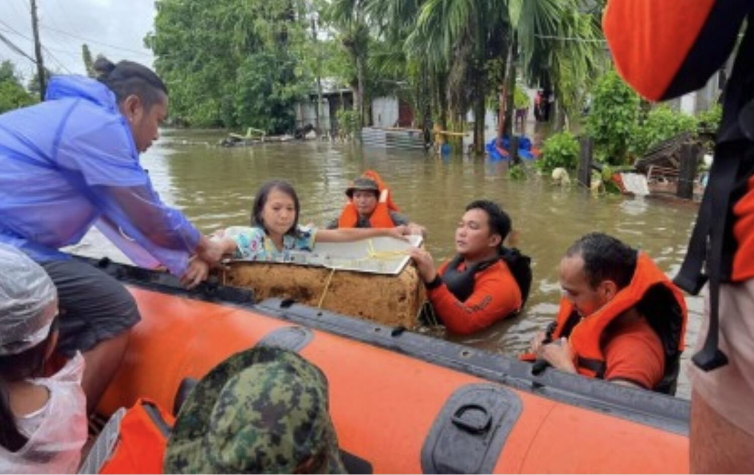 Philippine authorities rescue people trapped in flooding in Catarman, Northern Samar as heavy rains continue to fall due to wind shear and low pressure. Photo: Philippines Coast Guard