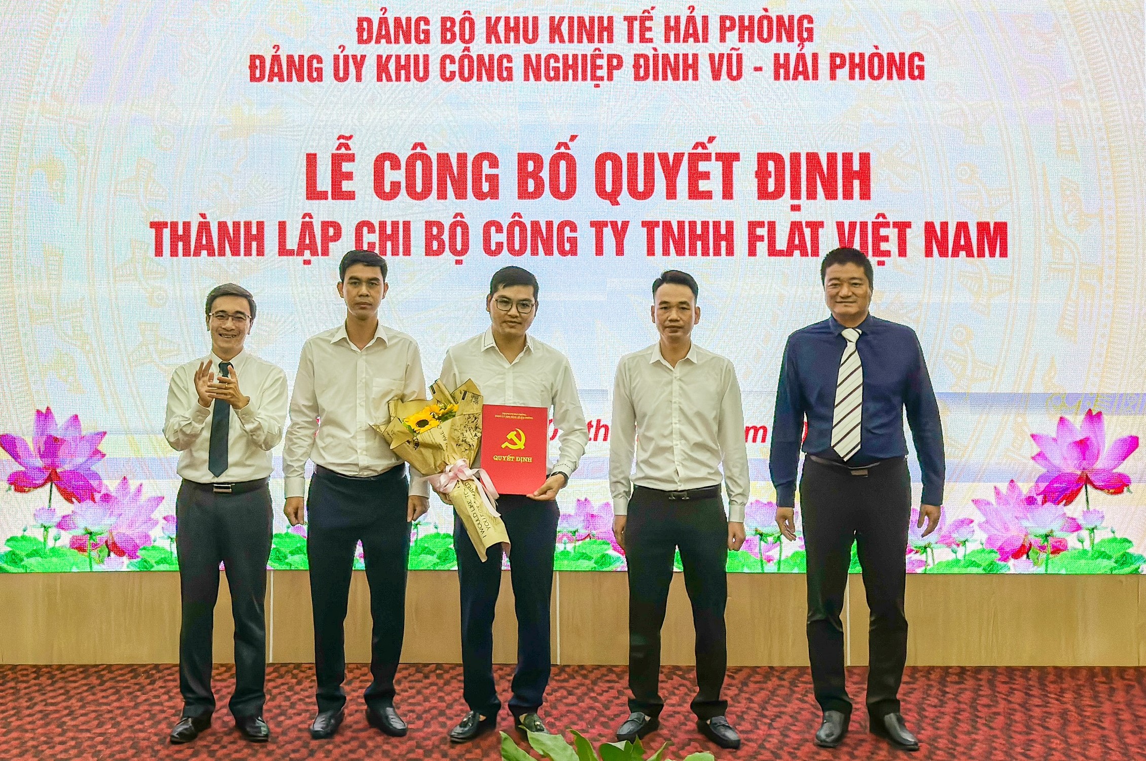 Lãnh đạo Đảng uỷ Khu kinh tế Hải Phòng và Đảng uỷ Khu công nghiệp Đình Vũ trao quyết định, tặng hoa chúc mừng chi bộ Công ty Flat Việt Nam. Ảnh: Lê Lê