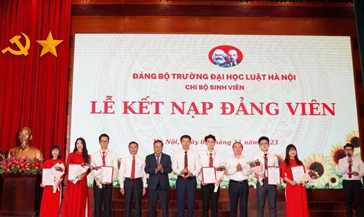 Phó Bí thư Thành uỷ Hà Nội Nguyễn Văn Phong trao quyết định kết nạp cho các đảng viên. Ảnh: HLU 