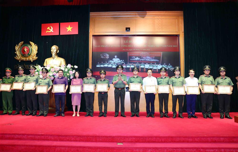 Bộ trưởng Tô Lâm trao Bằng khen tặng các tập thể, cá nhân có thành tích xuất sắc trong công tác xây dựng Luật sửa đổi, bổ sung một số điều Luật Công an nhân dân và hợp tác quốc tế về đấu tranh phòng, chống tội phạm.   Ảnh: Bộ Công an