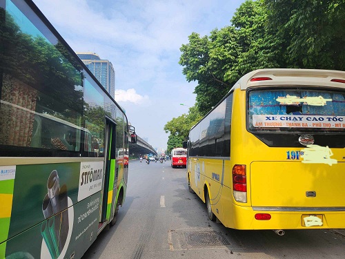 Xe chở khách dừng đỗ hàng hai trước cửa điể đón xe buýt  trên đường Phạm Hùng. Ảnh: Minh Hạnh chụp 12 giờ ngày 13.1.2.2023