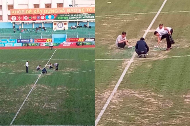 Ban tổ chức sân 19 tháng 8 xịt sơn lên mặt sân cỏ. Ảnh: Cắt từ video