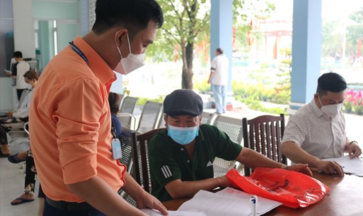 Cán bộ Phường Thạnh Lộc, Quận 12 hường dẫn hồ sơ hành chính cho người dân. Ảnh: Huân Cao