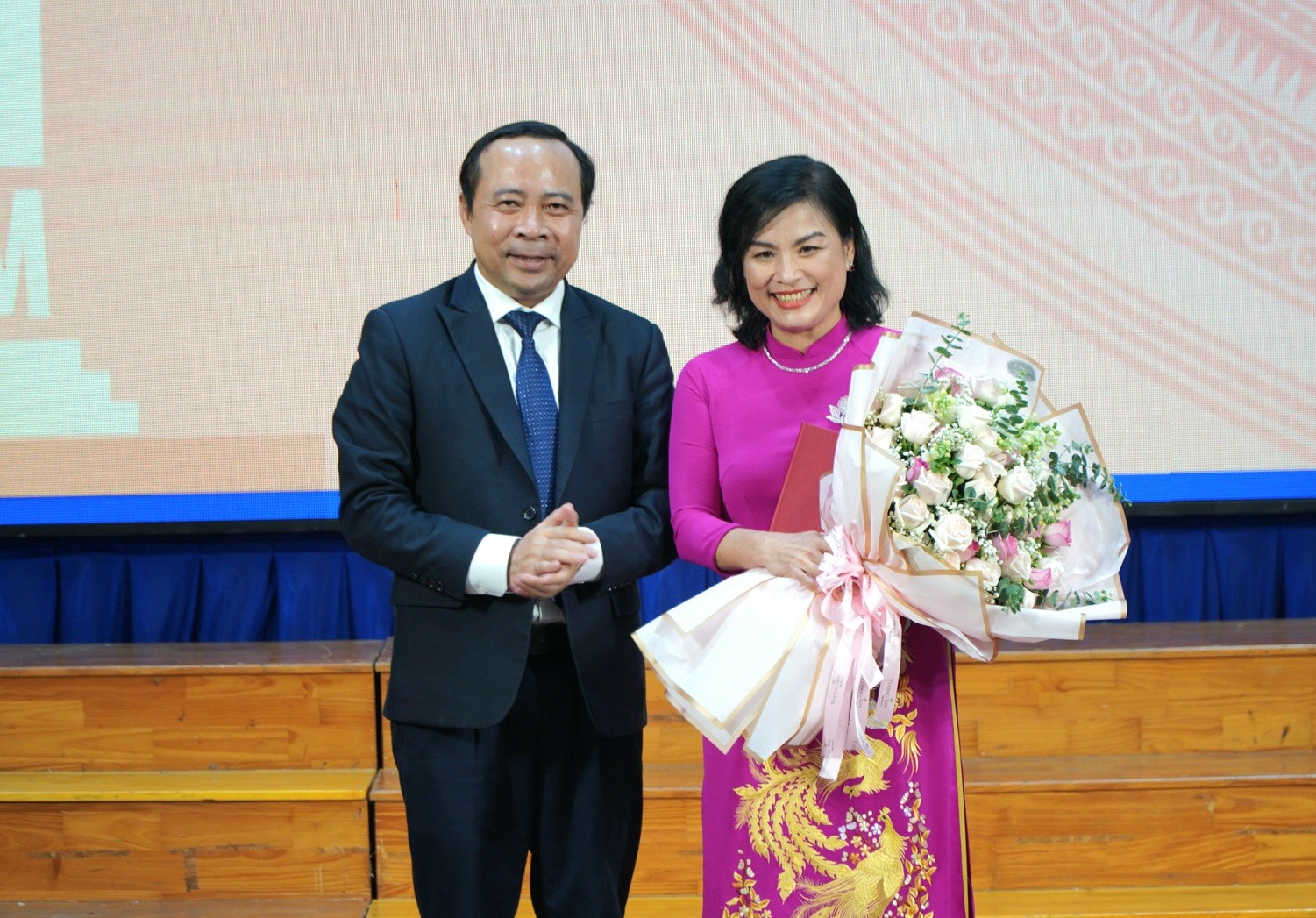 PGS.TS Ngô Thị Phương Lan nhận hoa, quyết định bổ nhiệm lại Hiệu trưởng. Ảnh: Chân Phúc