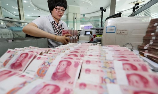 Một nhân viên ngân hàng ở Trung Quốc kiểm nhân dân tệ. Ảnh: Xinhua