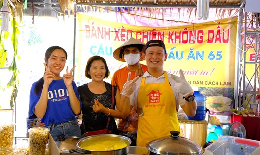 Anh Trần Chí Cương (bìa phải) buôn bán bánh xèo tại Lễ hội Bánh dân gian Nam Bộ lần thứ X năm 2023, cũng có nhiều trăn trở về lượng khách đến lễ hội ngày càng giảm. Ảnh: Phong Linh