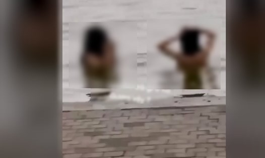 Hai nam thanh niên tắm ở hồ Gươm. Hình ảnh cắt từ đoạn clip.