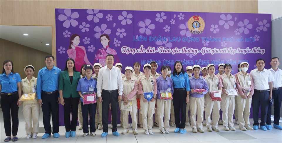 Lãnh đạo Liên đoàn Lao động thành phố Hà Nội trao tặng áo dài cho công nhân. Ảnh: Mai Quý