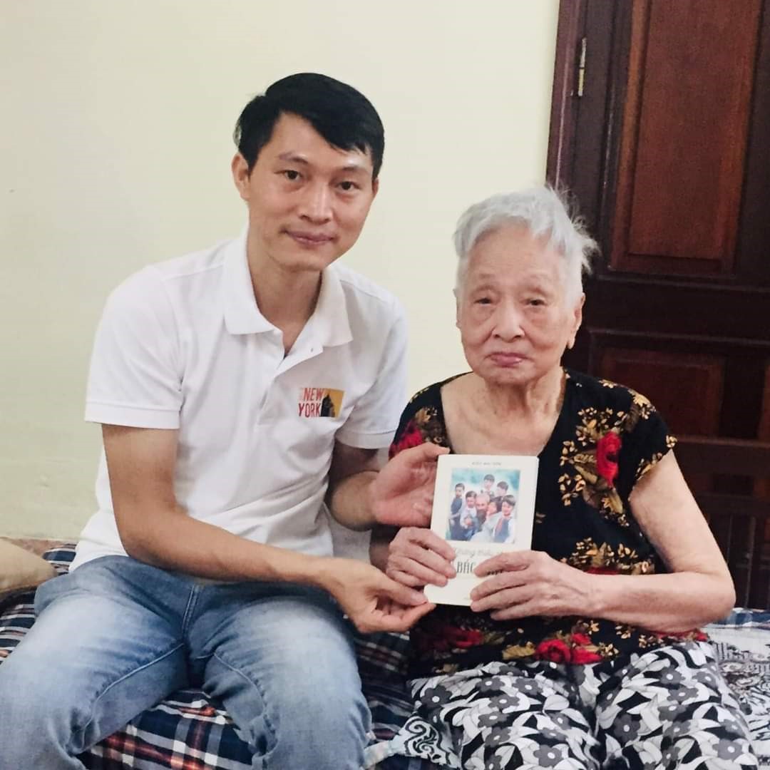 Tác giả Kiều Mai Sơn tặng sách tới cụ Đỗ Thị Phương là mẹ của bà Nguyễn Thị Quỳnh Dung - thiếu nhi có 7 tấm ảnh được chụp cùng Bác Hồ. Ảnh: Ái Vân