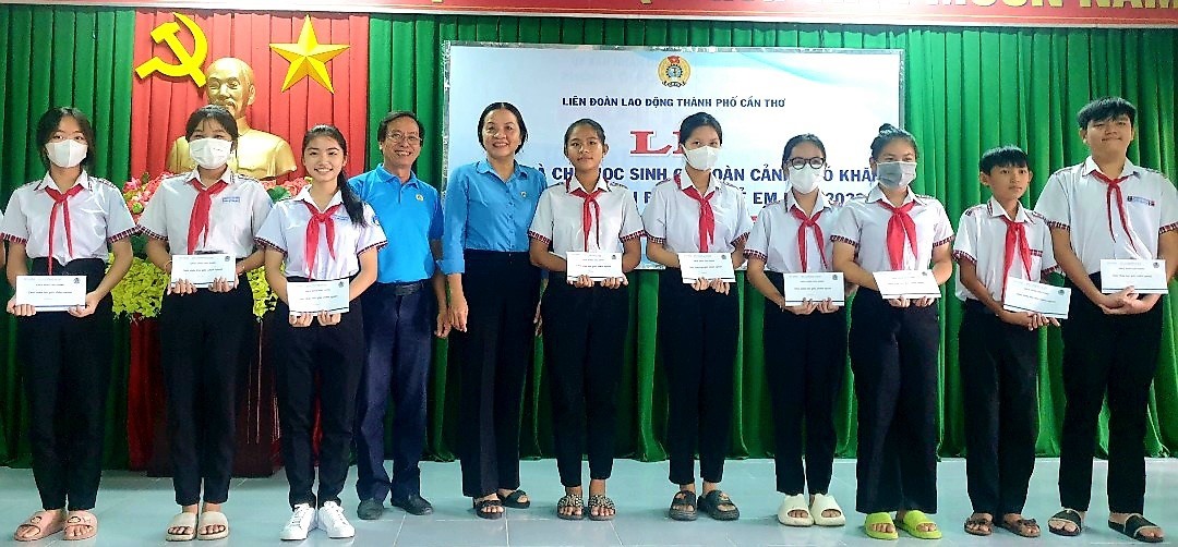 Phó Chủ tịch thường trực LĐLĐ TP Cần Thơ Huỳnh Thị Hiền và Chủ tịch Công đoàn cơ sở Công ty CP Dược Hậu Giang Võ Thanh Hùng trao học bổng cho các học sinh có hoàn cảnh khó khăn. Ảnh: Mỹ Ly