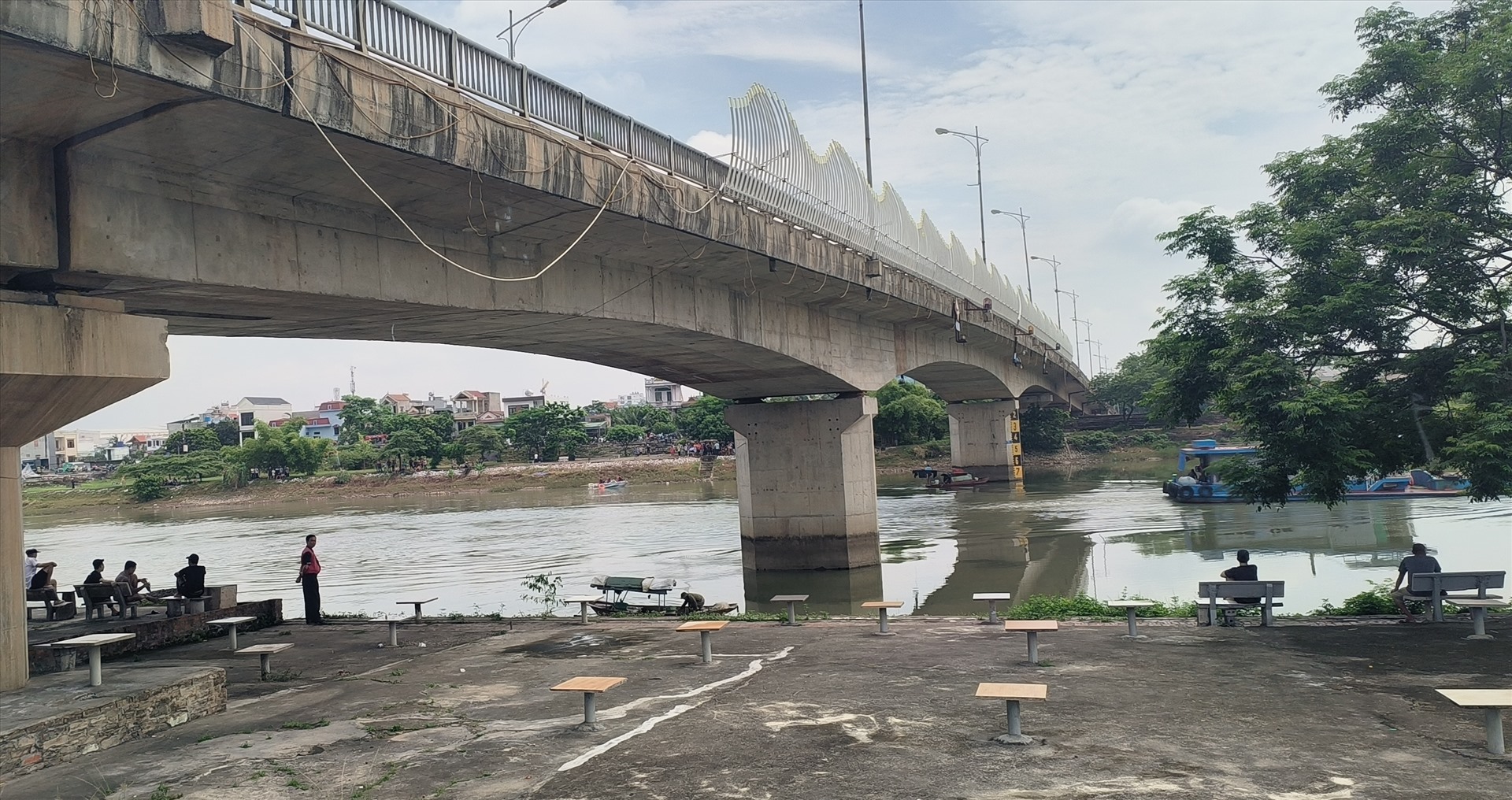 Người dân đứng hai bên cầu Bo theo dõi Đội cứu hộ cứu nạn 116 Thái Bình tìm kiếm nạn nhân đuối nước. Ảnh: Trung Du