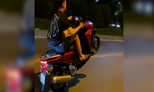 Nam thanh niên bốc đầu xe máy sau đó nhờ bạn quay clip đăng lên mạng xã hội. Ảnh: Cắt từ clip