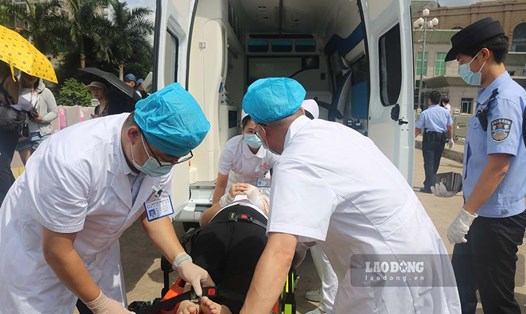 Lực lượng y tế Móng Cái (Việt Nam) chuyển giao người bị thương cho cơ quan chức năng Trung Quốc. Ảnh: Đoàn Hưng
