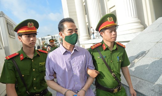 Cựu Thứ trưởng Bộ Ngoại giao Tô Anh Dũng bị dẫn giải vào phòng xử hôm 11.7. Ảnh: Quang Việt