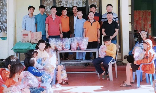 Cựu chiến binh Huỳnh Tấn Hùng (mặc áo khoác, đứng giữa) cùng các nhà hảo tâm tại Trung tâm Nuôi dưỡng trẻ em có hoàn cảnh đặc biệt khó khăn huyện Phú Ninh, Quảng Nam. Ảnh: Hoàng Bin
