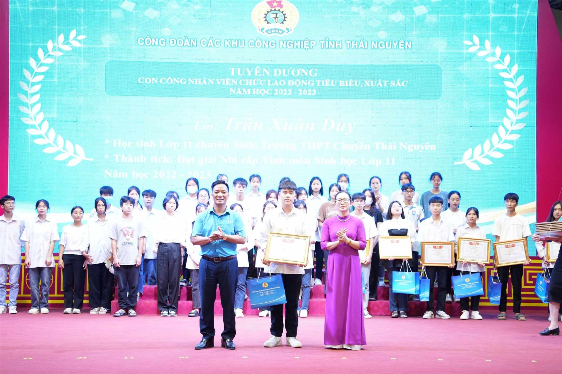 Bà Hoàng Thu Hằng – Phó Chủ tịch Thường trực LĐLĐ tỉnh và ông Dương Văn Thái trao quà cho học sinh đạt thành tích cao. Ảnh: Minh Hạnh 