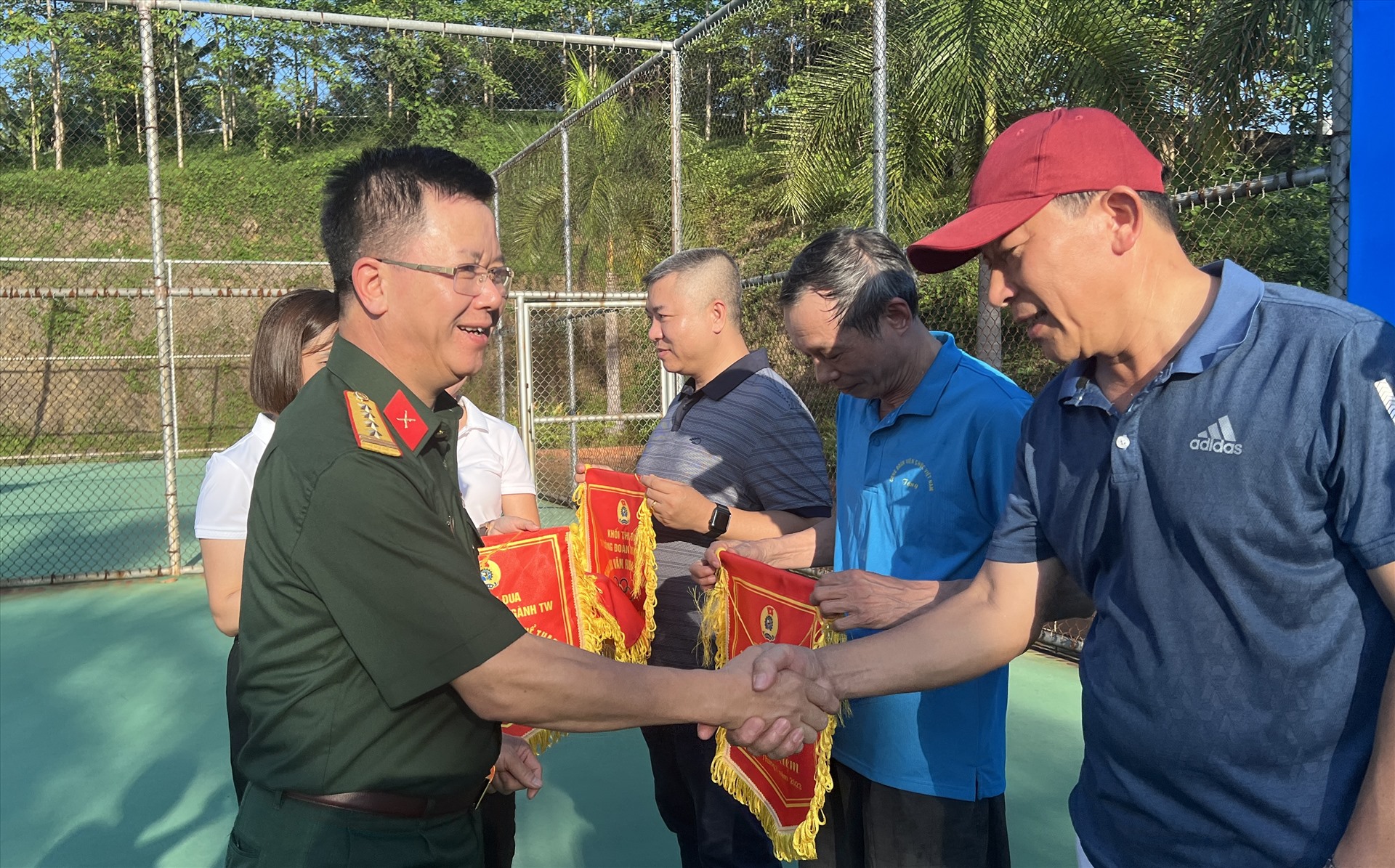 Đại tá Nguyễn Đình Đức trao cờ lưu niệm cho các vận động viên. Ảnh: Kiều Vũ