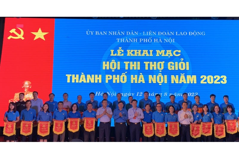 Phó Chủ tịch Tổng Liên đoàn Lao động Việt Nam Phan Văn Anh (thứ 8 từ trái sang) tới dự và trao cờ lưu niệm cho các đơn vị. Ảnh: Hải Yến