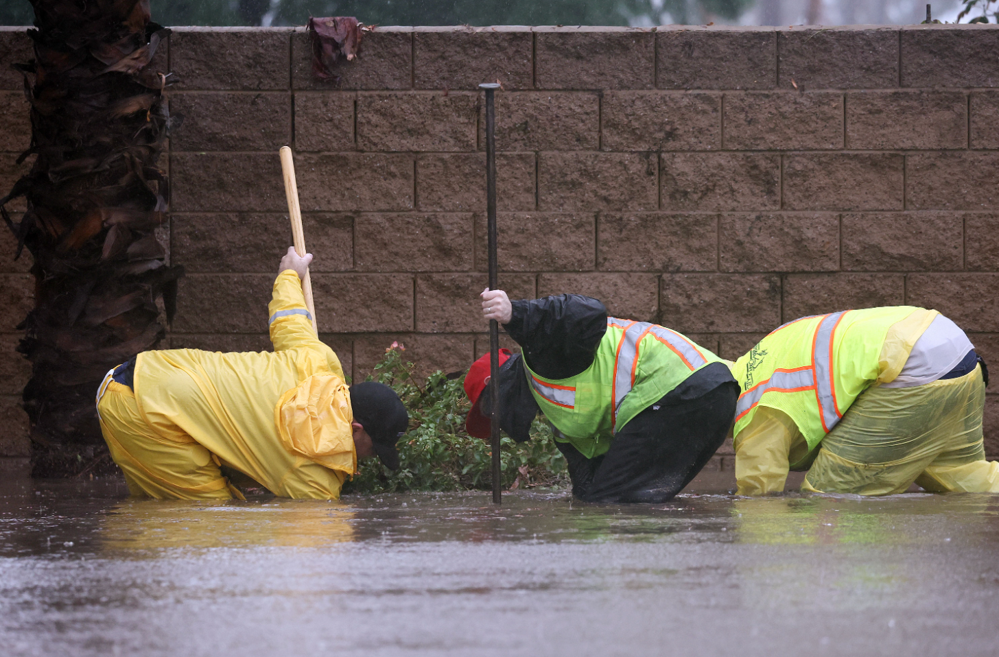 Công nhân thông cống trên một con đường ngập nước ở Rancho Mirage, California, ngày 20.8.2023. Ảnh: CNN