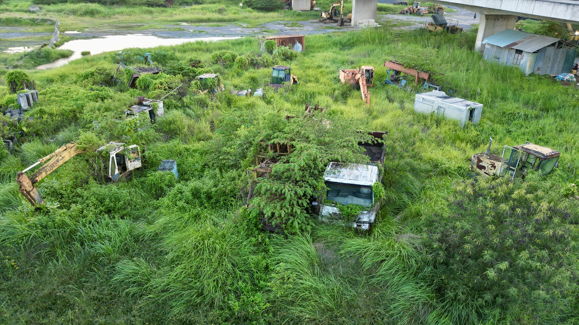 Máy móc phơi nắng mưa sau khi cao tốc Bến Lức - Long Thành ngưng trệ. Ảnh: Hữu 
Chánh