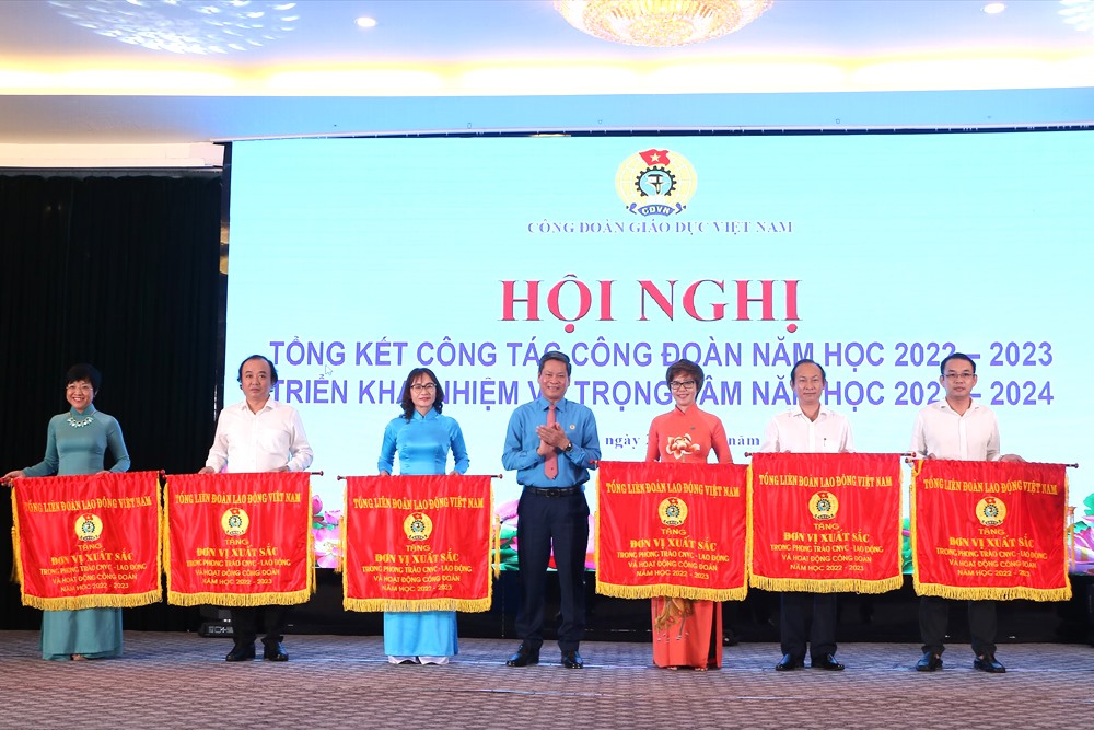 Ông Huỳnh Thanh Xuân - Phó Chủ tịch Tổng Liên đoàn Lao động Việt Nam - trao Cờ thi đua của Tổng LĐLĐVN cho các đơn vị xuất sắc thuộc Công đoàn Giáo dục Việt Nam. Ảnh: Đình Tuệ